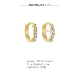 Detailed view of gold plated 925 sterling silver huggie earrings with zirconia stones