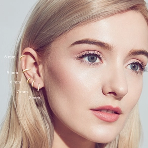 Close-up of gold turquoise hoop earrings set in multiple sizes 6mm to 9mm on ear