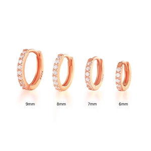 Detail of four S925 rose gold huggie hoop earrings with CZ stones in 6mm to 9mm sizes