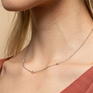 Close-up of minimalist S925 silver necklace with sparkling round cubic zirconia accents