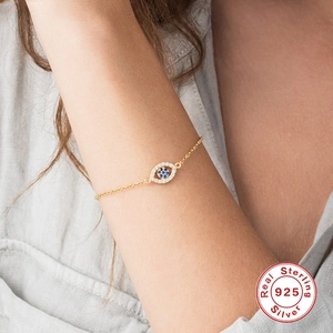 S925 sterling silver evil eye bracelet with blue zircon stones worn on wrist