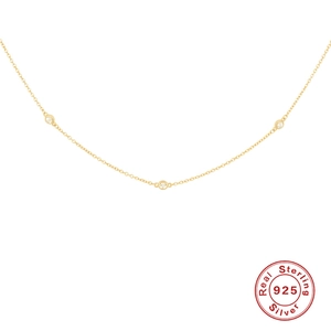 Detail of S925 sterling silver gold necklace featuring three clear zircon pendants