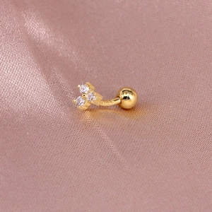 Macro view of gold S925 silver curved barbell stud with three sparkling zircon stones