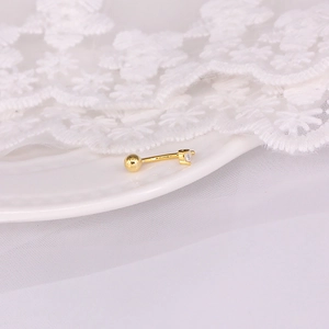 Detailed view of a gold-plated S925 silver helix stud with a tiny four-prong set zircon