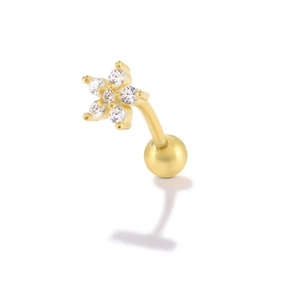 Macro detail of S925 silver curved barbell stud with gold flower and zircon inlay