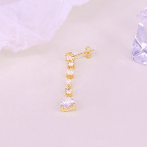 Detail of S925 silver gold-plated earring featuring drop and marquise cubic zirconia