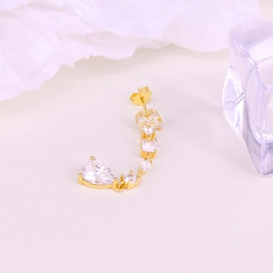 Macro shot of gold S925 silver hoop earring with marquise and teardrop zircon stones