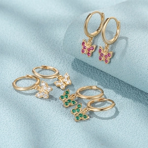 Macro shot of S925 butterfly earrings with colorful zircons on a light blue display