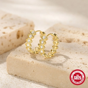 Macro detail of gold S925 sterling silver hoop earrings with marquise-cut zircon stones