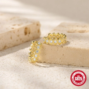 Macro detail of gold-plated S925 sterling silver hoop earrings with marquise-cut zircons