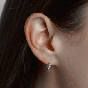 Close-up of minimalist S925 sterling silver hoop earring with white crystal pavé setting