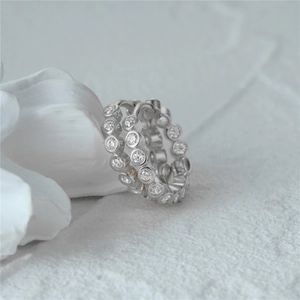 Macro detail of S925 sterling silver hoop earring with sparkling bezel-set zircon stones