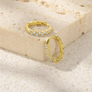 Macro detail of S925 sterling silver gold-plated hoop earrings with micro-set zircons