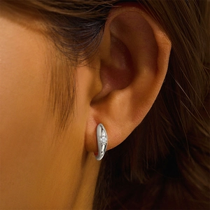 Close-up of S925 sterling silver hoop earring featuring star pattern and inset cubic zirconia