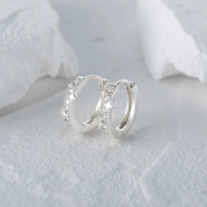 Detailed view of S925 silver huggie earrings with pavé set zircon star elements