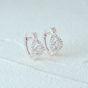 Macro shot of silver infinity earrings with sparkling pave-set stones and round crystals