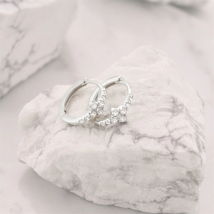 Detailed close-up of s925 silver hoop earrings featuring clover cubic zirconia inlays