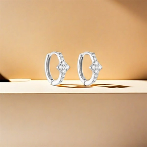 Macro shot of S925 silver hoop earrings with star charms and sparkling zircon inlay