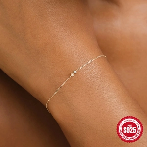 Close-up of a delicate S925 sterling silver bracelet featuring a tiny pearl and zircon