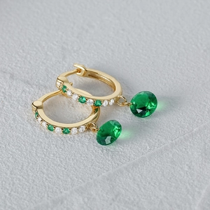 Detalle de pendientes de plata s925 dorada con esmeraldas verdes y piedras de circón