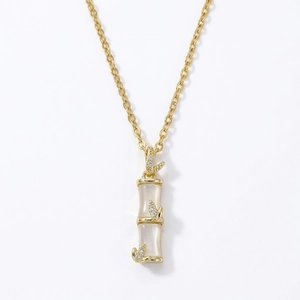 Elegant gold bamboo joint pendant necklace with white stone and zircon leaf accents