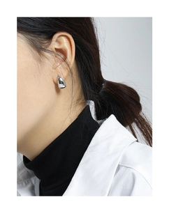 Polished silver geometric oval stud earring shown on model for elegant minimalist style
