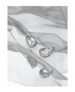 Macro detail of silver S925 geometric oval earrings with a polished mirror finish