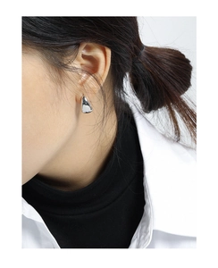 Close-up of minimalist oval sterling silver stud earrings worn on model for detail