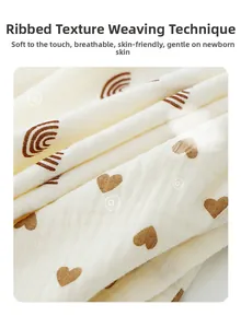 Detail of crinkle cotton baby gauze with soft heart and rainbow prints for newborns