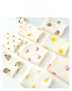Detail of soft multi-layer cotton baby gauze towels with cute cartoon prints and hanging loops