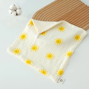 Close-up of 100% cotton baby washcloth with sun pattern and hanging loop detail