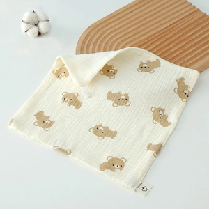 Macro detail of breathable 100% cotton baby towel with bear pattern and hanging loop