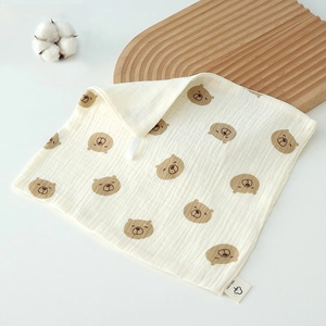 Detail of 100% cotton baby muslin towel with cute bear prints and hanging loop feature