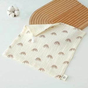 Detail of soft cotton baby washcloth featuring brown rainbow print and hanging loop