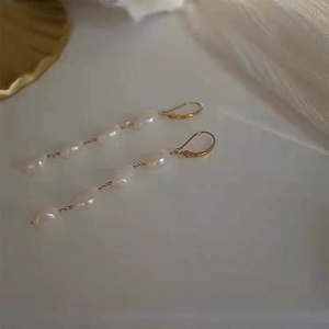 French baroque gold long drop earrings featuring four natural freshwater pearls