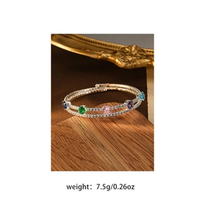 Detail of double-layer open bangle with colorful zircons and premium gold plating