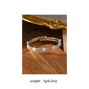 Detail view of double-layer silver-tone bracelet with sparkling crystals and stars