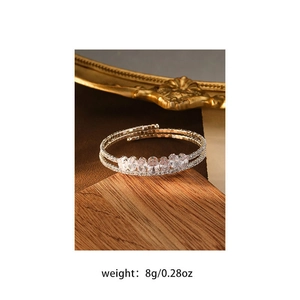 Macro detail of silver layered open bracelet with zircons and 8g weight specification