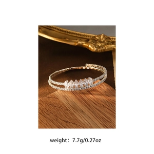 Macro shot of silver-colored layered bracelet with marquise-cut marquise zircon gems