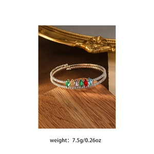 Detail view of double-layer gold bangle with colorful marquise stones and zircons