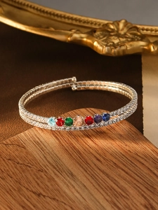 Detailed view of silver wrap bracelet with multi-colored zircon stones and micro-pave setting
