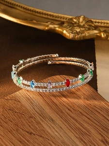 Detailed macro of silver double-layer spiral bracelet with colorful marquise stones