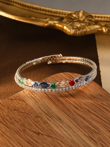 Macro detail of multi-layered bracelet with colorful marquise-cut gems and micro zircons