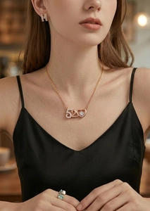 Macro detail of rose gold 520 heart pendant with sparkling cubic zirconia on a necklace