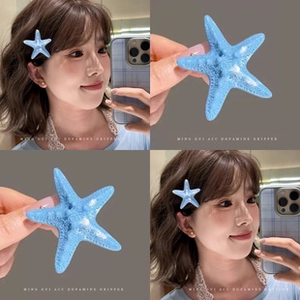 Detail of light blue starfish hair claw clip with realistic texture for high ponytail styling