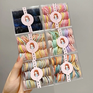 Detail of 6-pack colorful elastic hair ties in transparent square storage boxes