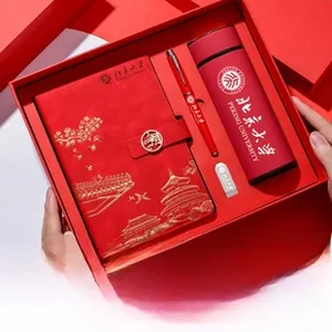 Corporate business gift set featuring red leather notebook, vacuum cup, and metal pen