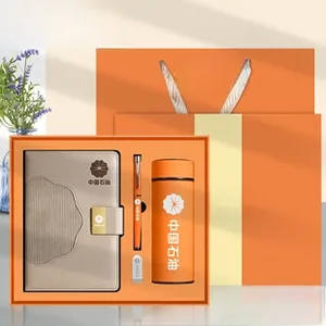 Business gift set with A5 leather notebook, thermos cup, pen, and USB drive in orange and gray