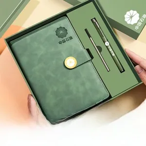 Detailed view of dark green leather notebook gift set with matching metal pen in gift box