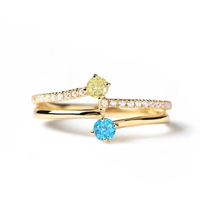 Macro view of double-layer gold plated ring with blue and yellow round gemstones